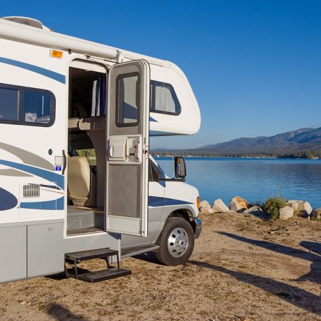 rv parked in front of lake